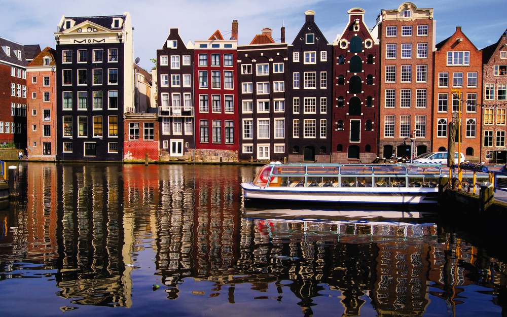 Traditional houses of Amsterdam with canal reflections