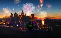 Feuerwerk über beleuchtetem Schloss bei Nacht