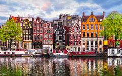 Amsterdam Netherlands dancing houses over river Amstel landmark
