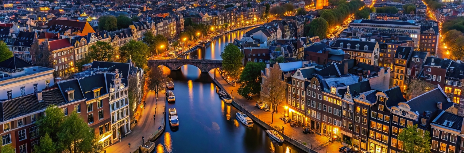 Aerial view of Amsterdam canals and old center district at night, Amsterdam, Netherlands, aerial view