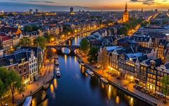 Aerial view of Amsterdam canals and old center district at night, Amsterdam, Netherlands, aerial view