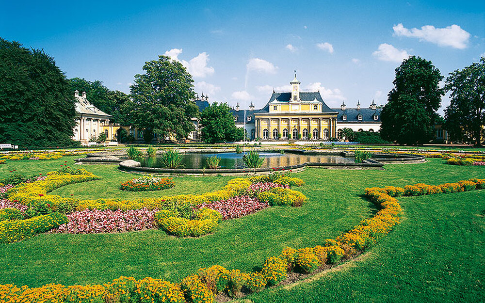 Schloss Pillnitz mit blühendem Garten im Vordergrund in Dresden.